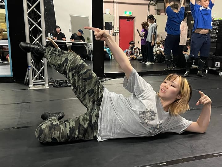 床に寝そべって脚を上げ、指をさすポーズをとる団員|劇団カスタリア ダンス基礎練習