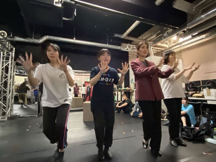 両手を顔の横で広げる振付を、横一列にそろえて踊る出演者たち｜劇団カスタリア「清子と桃香」稽古