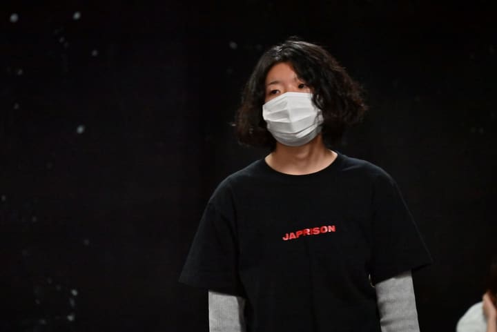 黒い舞台を背に、黒のTシャツ姿で正面を見据える団員｜劇団カスタリア 通し稽古