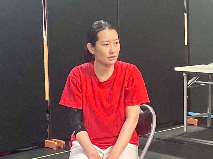 パイプ椅子に腰かけ、静かに前方を見つめる出演者｜劇団カスタリア 演技稽古