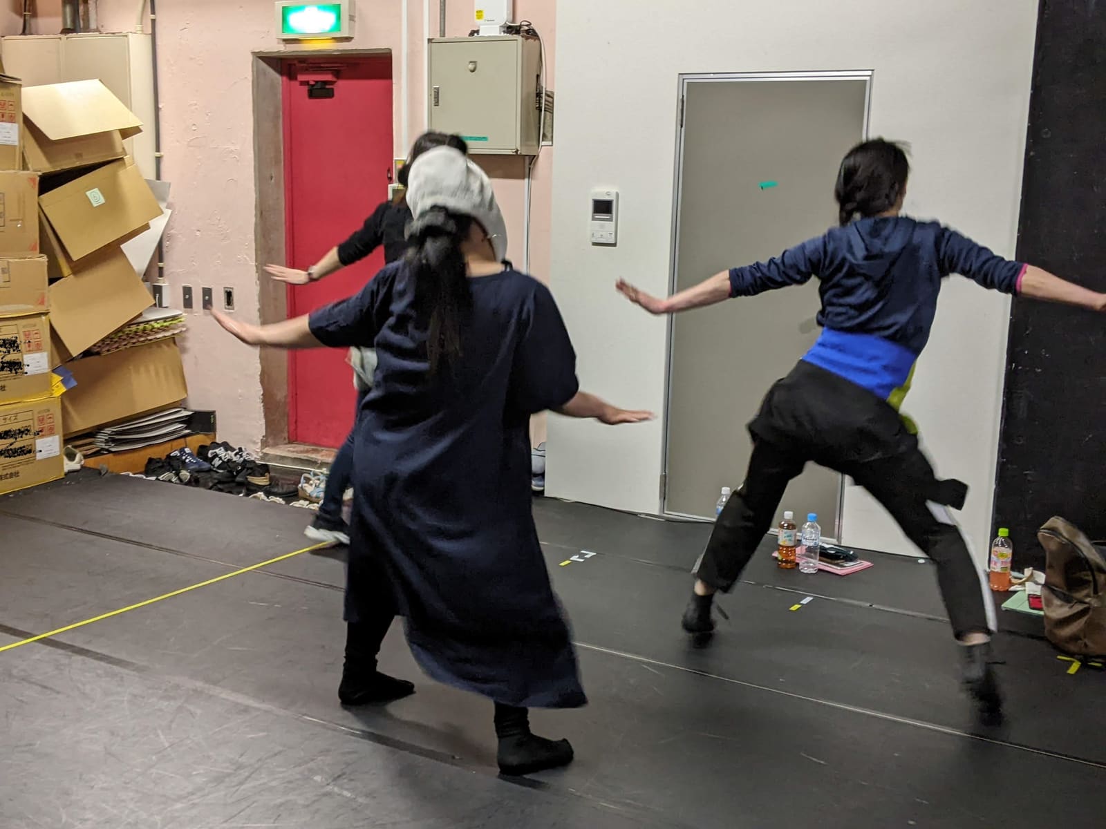 両腕を横に大きく開き、脚を踏み込んで踊る団員たち｜劇団カスタリア ダンス稽古